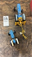 Two small blue toy tractors
