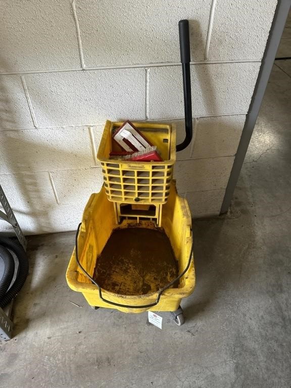 Mop, bucket with mop press has caution logo on