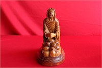 A Carved Praying Man on Stand
