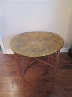 An Etched and Carved Copper and Teak Tray Table