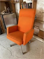 Orange Rolling chair with books and misc
