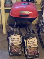 CHARCOAL GRILL AND BAGS OF BRIQUETS