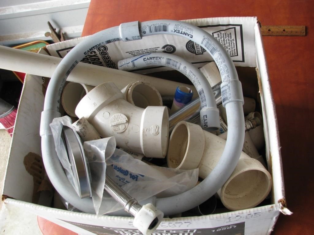 Box of unused plumbing supplies