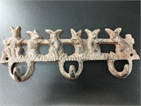 Brand new cast iron triple wall hook, depicting se