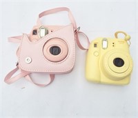 Instax Cameras. Pastel Pink and Pastel Yellow.
