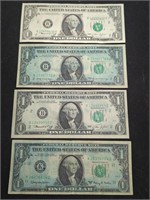 Four 1963-1974 $1 US paper money bills.