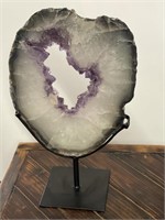 Large amethyst quartz geode specimen on stand