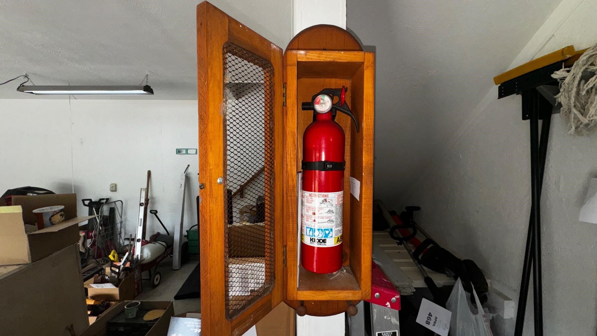 Fire extinguisher in a Wooden cabinet.
