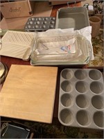 Small wooden cutting board, baking pans glass