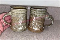 (2) Burkett signed pottery mugs (K)
