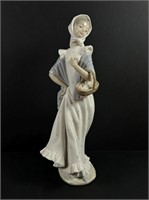 Lady with basket figurine. By LLADRO.