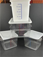 4 Plastic measuring containers with lids.
