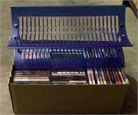 Box of DVDs and a blue DVD display stand. DVD
