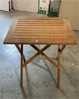 Folding teak wood patio table measures 27