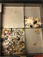 Quantity of jewelry pieces left in metal drawer