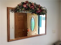 Wall mirror and floral arrangement