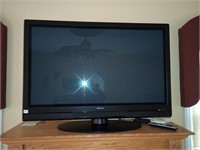 Hitachi 50 inch TV on a swivel stand with remote.
