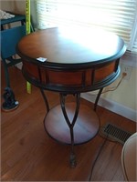 Great round wood and metal table. Approx 27