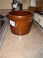 Small chocolate brown crock, handle is missing.