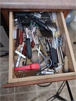 Drawer contents including spoons, spatulas, and