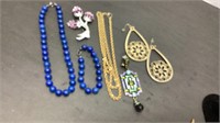 Jewelry lot of Nolan Miller purple pin, blue