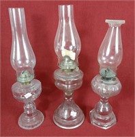Trio of oil lamps with hurricane shades