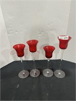 FOUR TALL CANDLEHOLDERS