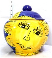 Pottery jar w/ smiling sun on front