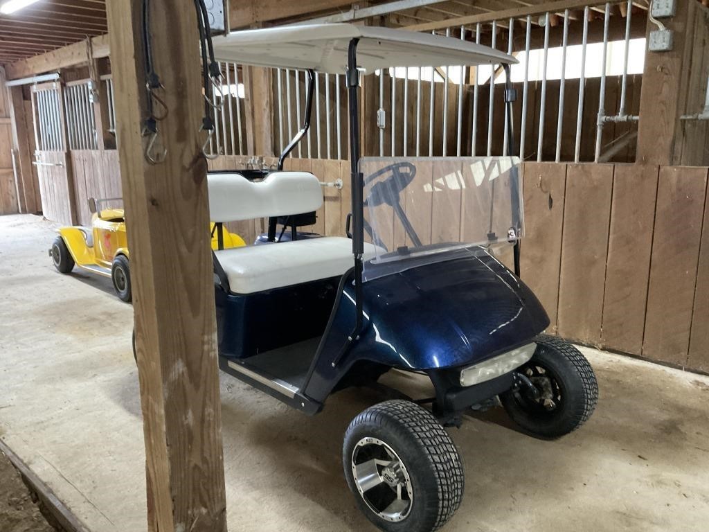Blue EZGO golf cart, with “Jake’s” lift kit