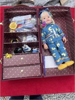 Baby doll in case with clothing and accessories