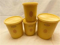 Set of 4 Tupperware yellow canisters.