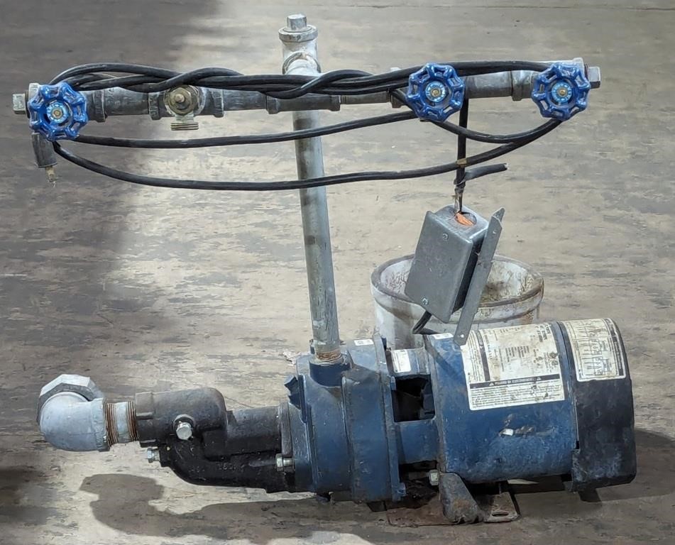 (J) Pump motor with pipes and valves.