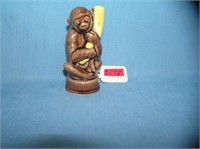Porcelain glazed monkey and banana figurine