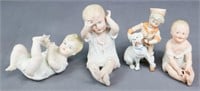 4 Bisque Porcelain Piano Baby Figurines