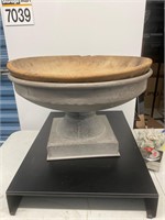 Old wooden bowl with metal stand