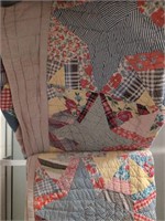 Vintage hand stitched quilt has some wear