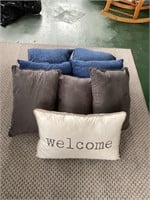 Assorted blue and gray decorative pillows
