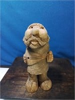 Carved wooden island man playing instrument 9