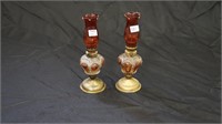 Two glass oil lamps.