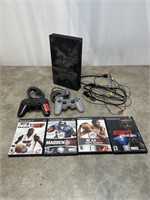 PlayStation 2 gaming console with controllers and