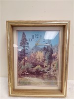 Framed nature scenery with clock