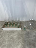 Green short stemmed wine glasses and glass vase.
