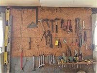 Hand tools on wall to include adjustable wrench,