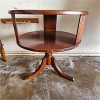 Leather top round 3 legged table.