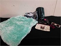 Cute green accent rug, makeup bags, and