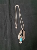 Necklace with bird pendant and turquoise colored