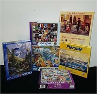 Five 1000 piece puzzles and one 550 piece puzzle