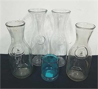 Four carafes and a candle holder