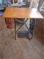 End table on an antique cast iron sewing base