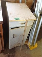 Small white metal cabinet, rusty at bottom